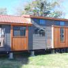 The Austin model by Platinum Cottages on display @ RRC Athens. This Tiny House Jamboree show model features a unique exterior, double porches, tall ceilings throughout with cedar beams & more!