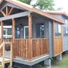 The Austin model by Platinum Cottages on display @ RRC Athens. This Tiny House Jamboree show model features a unique exterior, double porches, tall ceilings throughout with cedar beams & more!