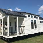 White Farmhouse Premier P577 with grey painted cabs, clerestory, and an optional island by Platinum Cottages. This custom built house was for an RRC Athens customer.