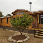 Bronze metal skirting to match roof. House is Mahogany stained Hardi.