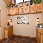 The Timberline 566SLFP model by Platinum Cottages and RRC Athens. This rustic park model cabin is shown with many upgrades including cedar interior pkg with Hickory cabs, a front porch, loft, washer/dryer front loads installed, and more!!