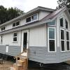 The Stillwater model P-571 by Platinum Cottages and RRC Athens. Shown with Clerestory windows and 5 rows of lap siding accent around the bottom.